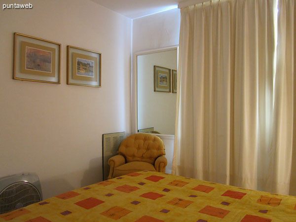 Detail of bed in the master bedroom seen from the left corner by the window.<br><br>It offers views to the east over the peninsula along Gorlero Avenue.