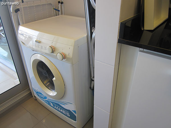 Laundry space in the kitchen next to the exit to the terrace balcony.