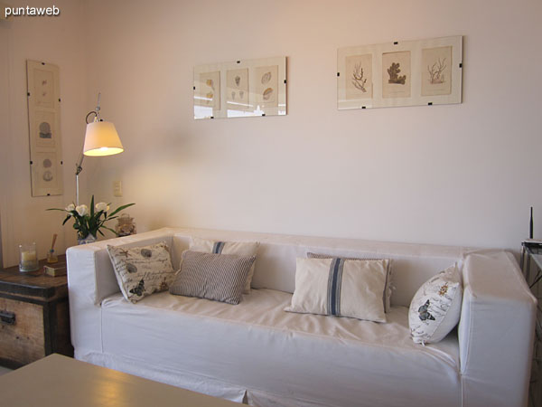 View of being in the living room. Equipped with three bodies chair, two chairs and wooden coffee table.