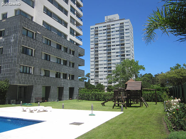 General view of the outdoor pool from the back left corner of the property into the building.