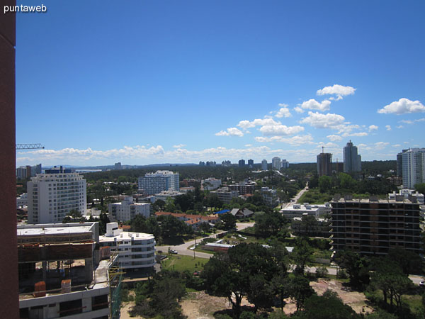 View from the balcony towards the sector of outdoor pools in the garden of the east side of the property.