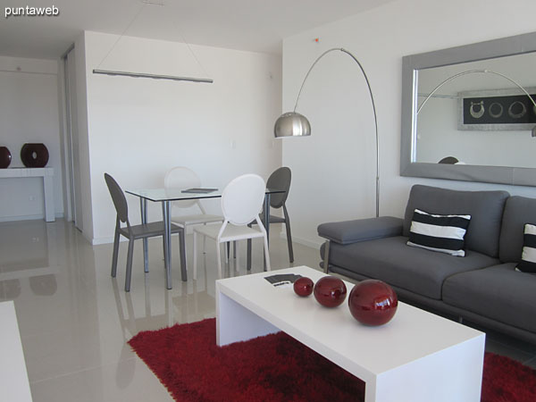 General view of the living room from the right corner by the window leading to the terrace balcony.