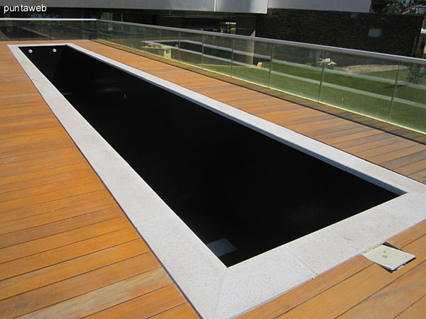 Building facade from the wooden deck where the outdoor pools.