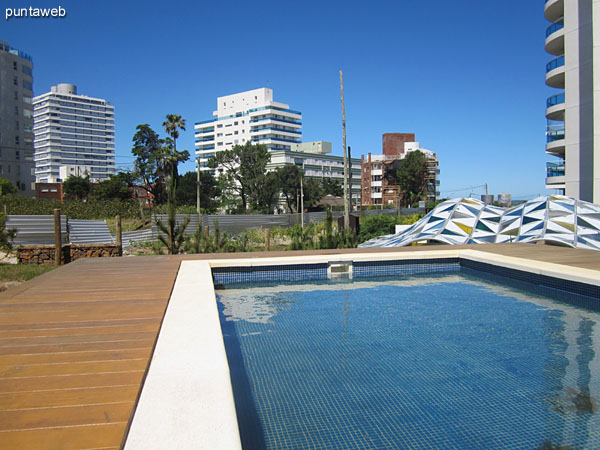 Child pool on the large wooden deck overlooking the garden of the property.