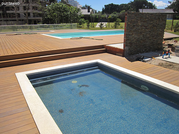 View of the pool for children in the large wooden deck of the property to the east.