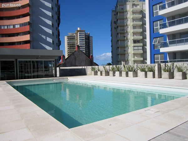 Espacio de piscinas y barbacoas en el jardn trasero del edificio.