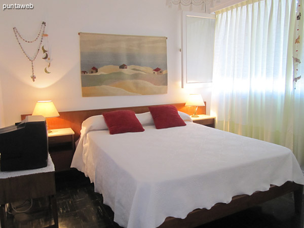 General view of the living room from the left corner by the window to the hallway leading to the bedrooms.