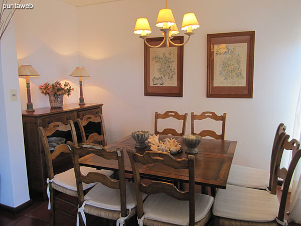 Dining space. Located on the corner of the south side and the facade of the building. <br><br>Conditioning wood square table with eight chairs. <br><br>The window provides a view to the front of the building on 6th Street.