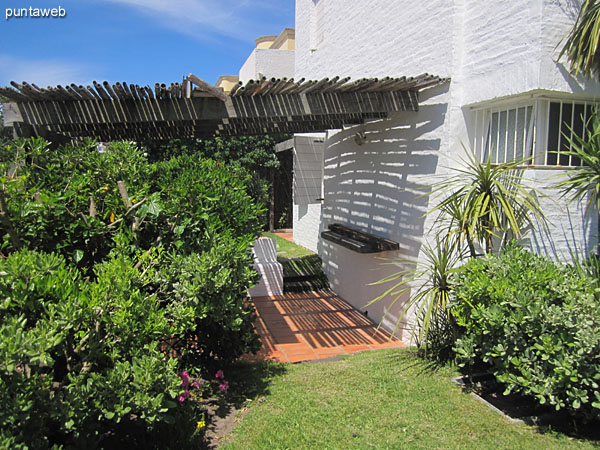 General view of courtyard garden with pergola next to the apartment from the backyard to the front yard.