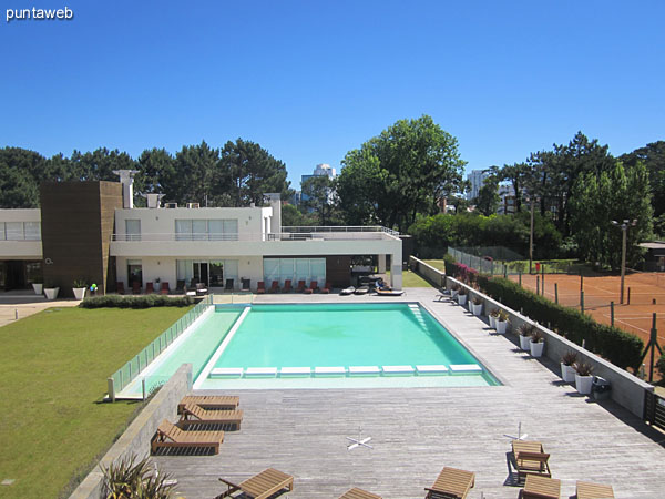 View to the garden center and barbecues and outdoor pool area from the balcony of the living room.