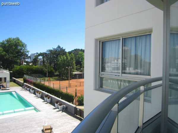 General view of the outdoor pool and solarium space from the apartment balcony.