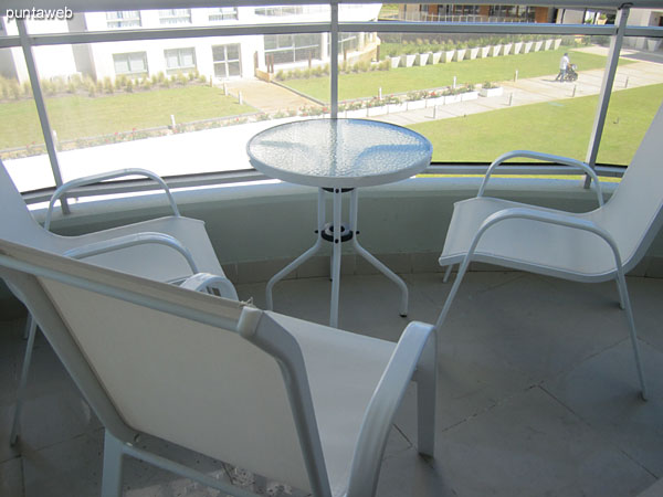 Detail balcony enclosure.<br><br>In the background, outdoor pool and tennis court.