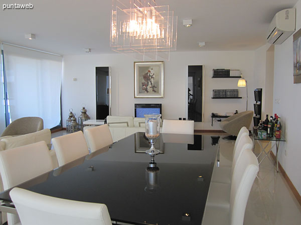 Detail dining space. Conditioning with metal and glass table with eight chairs.