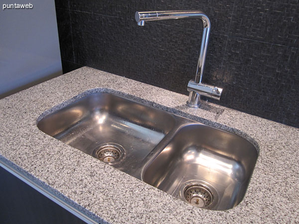 Kitchen with glass–ceramic four–burner stove and hood.