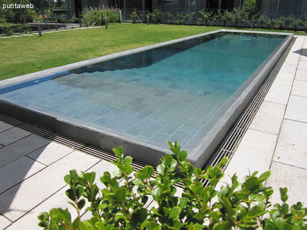 Outdoor pool equipped with sun loungers and parasols.