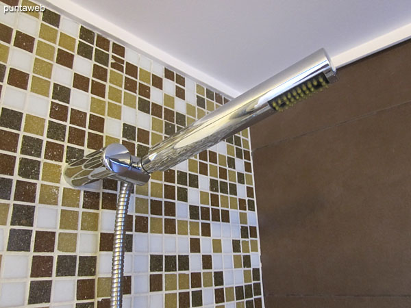 The en–suite bathroom is equipped with shower, tub and shower curtain.