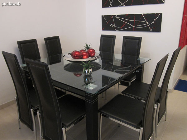 Detail dining space. Equipped with large glass table with eight matching chairs.