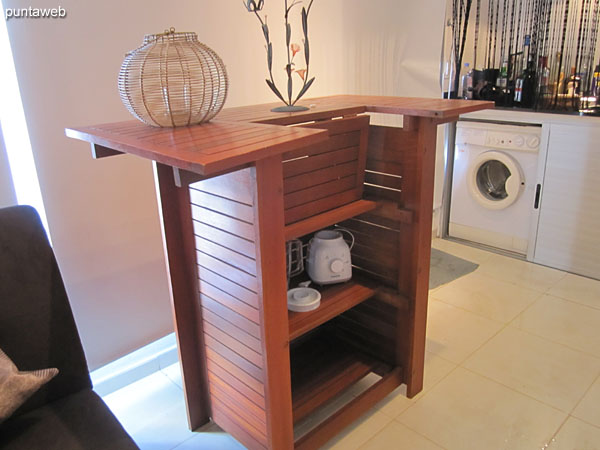 View to the north side on the second floor of the duplex. At the bottom of the image the second grill and service area with table and washing machine.