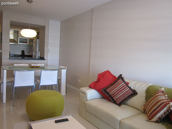 Dining area in the living room. Conditioning with frosted glass table and six chairs to match.