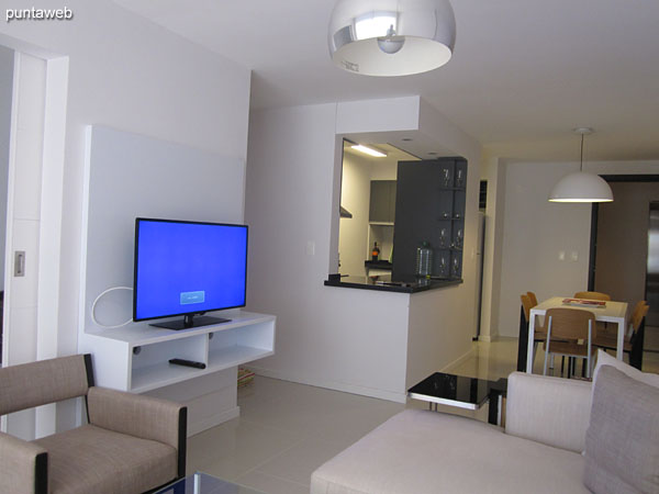 Living room environment.<br><br>In the foreground the dining table. To the right of the image American style kitchen.