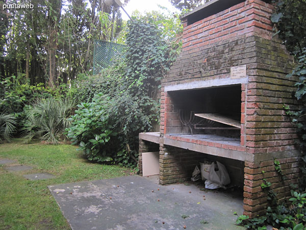 Outdoor barbecue in common use located in the backyard of the building on the north side.