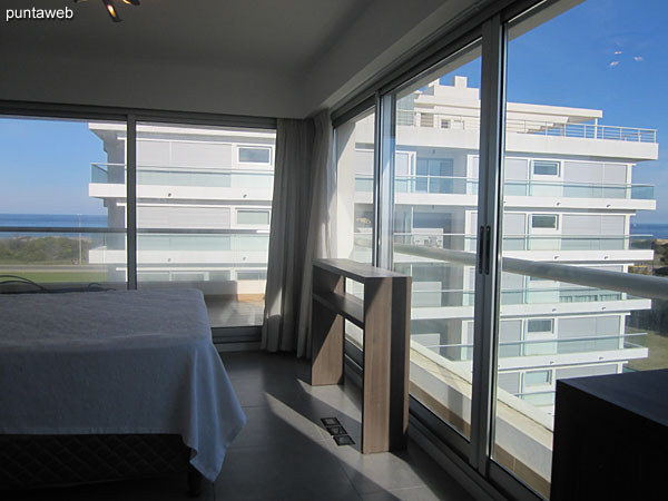 Overview of the suite from the corner by the windows and access to the terrace balcony.<br><br>To the left of the image the floor to ceiling wardrobe with mirrored doors and bathroom.