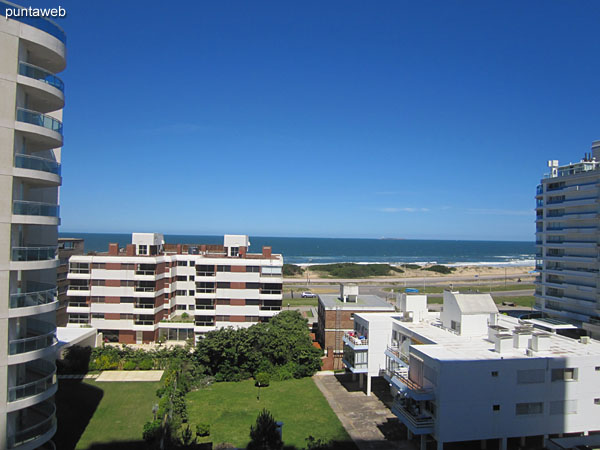 Balcony equipped with glass and rattan table with six chairs simile.