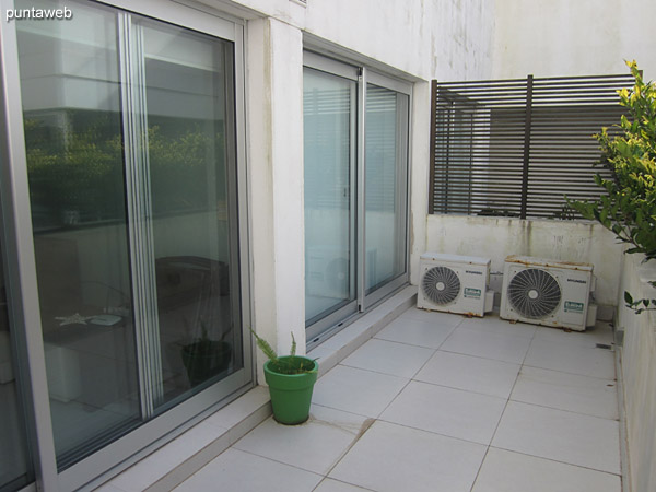 Balcony terrace accessible from living room and bedroom. It has a square table with four chairs.