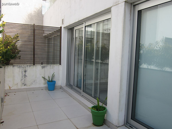 Balcony terrace accessible from living room and bedroom. It has a square table with four chairs.