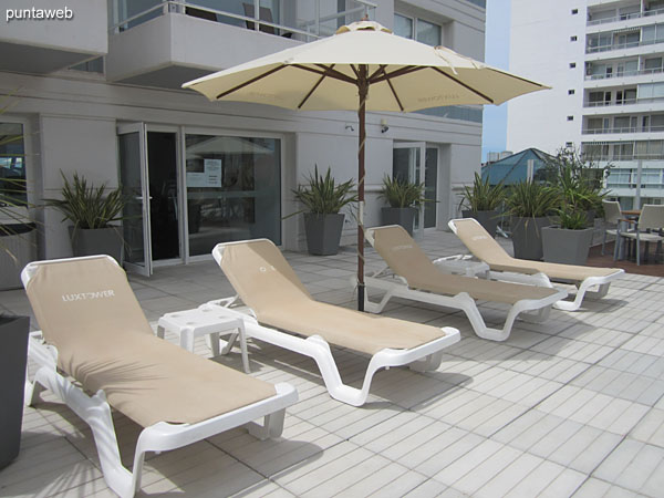 Parasols and sun loungers in the outdoor pool area located on the second floor terrace.