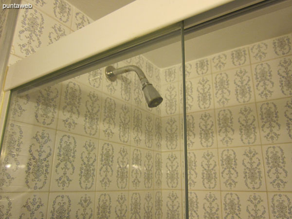 The second bathroom has a shower and bath screen.