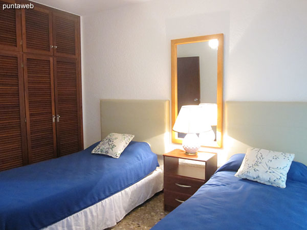Third bedroom. Located towards the north side. It has two single beds, ceiling fan, air conditioning and large wardrobe / closet in wood.