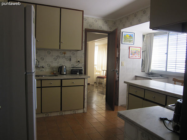 Kitchen, spacious, accessible from the dining space and the hallway to the bedrooms and service bedroom.