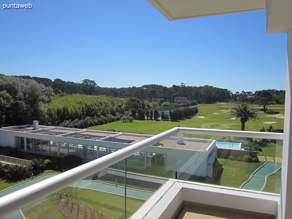 The green space consists of a four–hole golf course.<br><br>In the foreground the barbecue with two grills next to the outdoor pool.