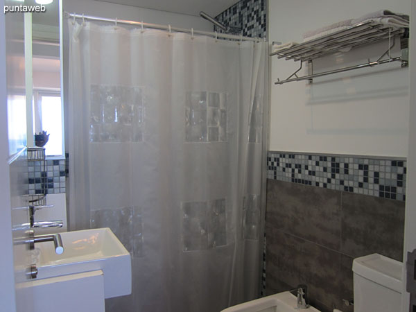 Second bathroom Interior, equipped with shower and bathroom curtain.