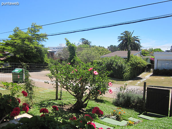 View towards the surroundings of the fenced garden in front of the apartment from the bedroom window.