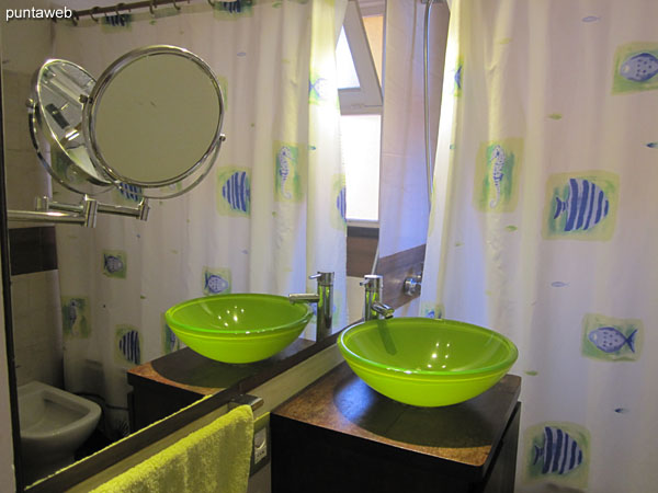 Bathroom, complete; with exterior window. It has a shower, bathtub and shower curtain.