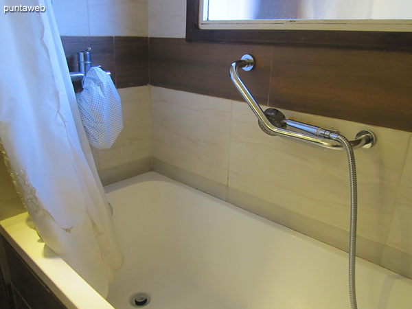 The main bathroom has a bathtub and a shower curtain.