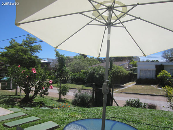 View towards the garden of the apartment and along the side street from the door–window of the second bedroom.