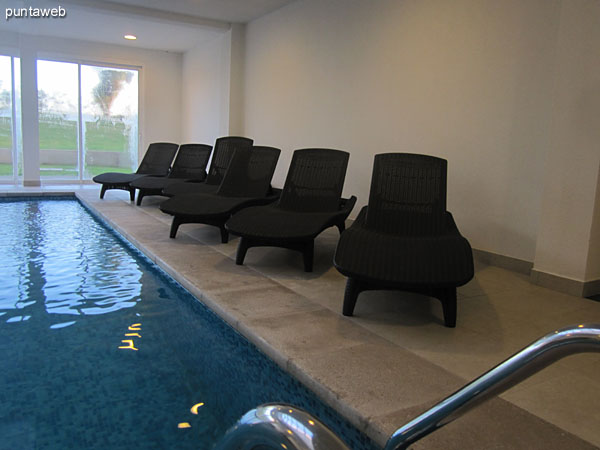 Detail of chairs in the heated pool of the building.