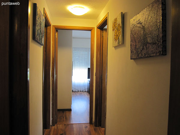 Hallway to the bedrooms with a door to the living room.