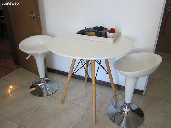 Table with two chairs arranged in the kitchen.