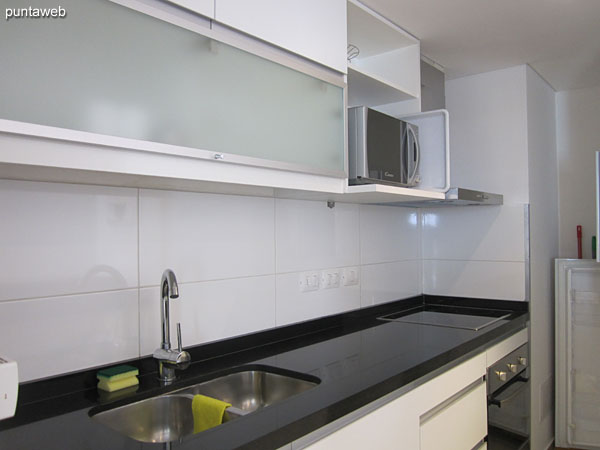 Kitchen interior. Arranged with bar on the living room environment.<br><br>Equipped with a simple counter with sink, furniture on and under table.