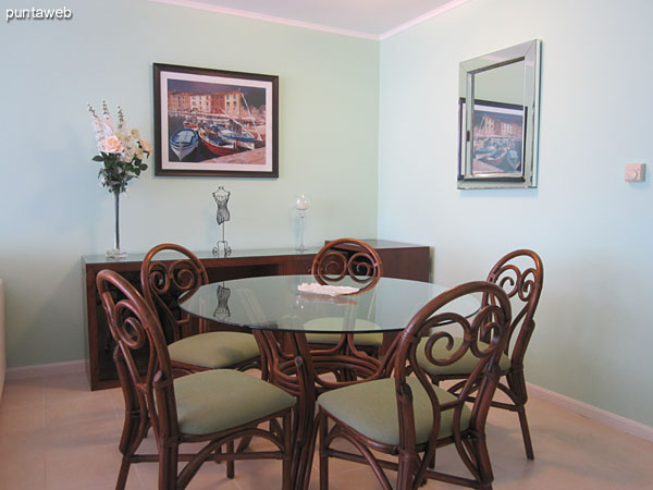 Dining space located to the right of admission.<br><br>Conditioning with round wood and glass table with five chairs.
