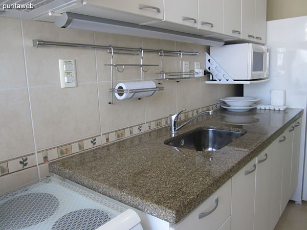 Kitchen. Located below the atmosphere of living room with outside window in the laundry room to the front.<br><br>Fitted with low furniture and countertops.