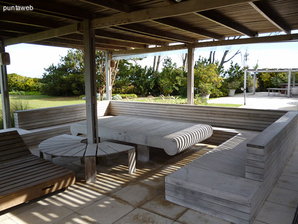 Segunda pergola con reposeras, bancos y mesas en madera, en días de verano se decoran con telas para crear un ambiente fresco para descansar al aire libre y a la sombra.